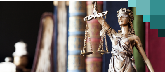 A statue of Lady Justice with books in the background