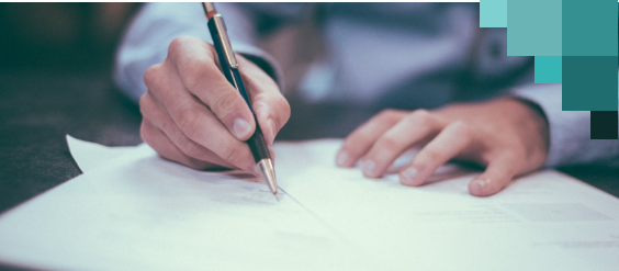 A person writing on a sheet of paper